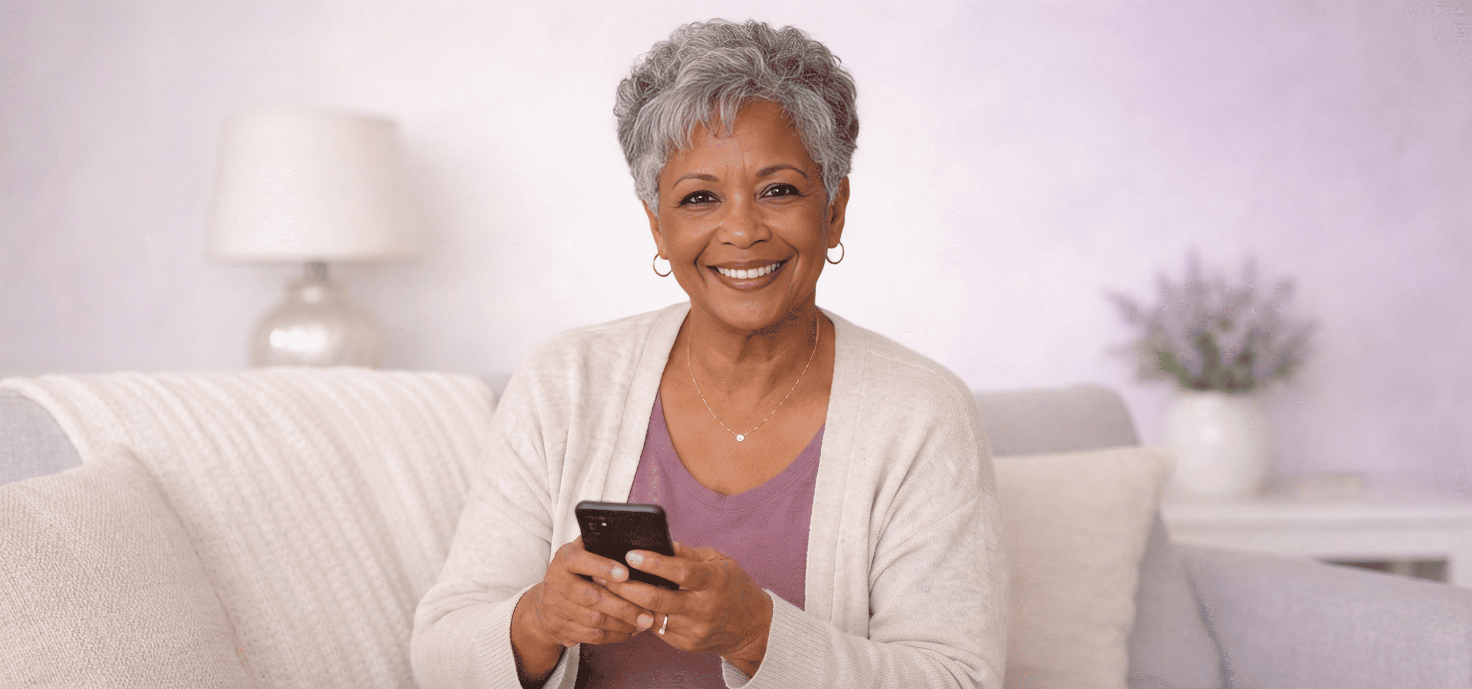 A grandmother using her phone at home, supported by AI cardiac monitoring